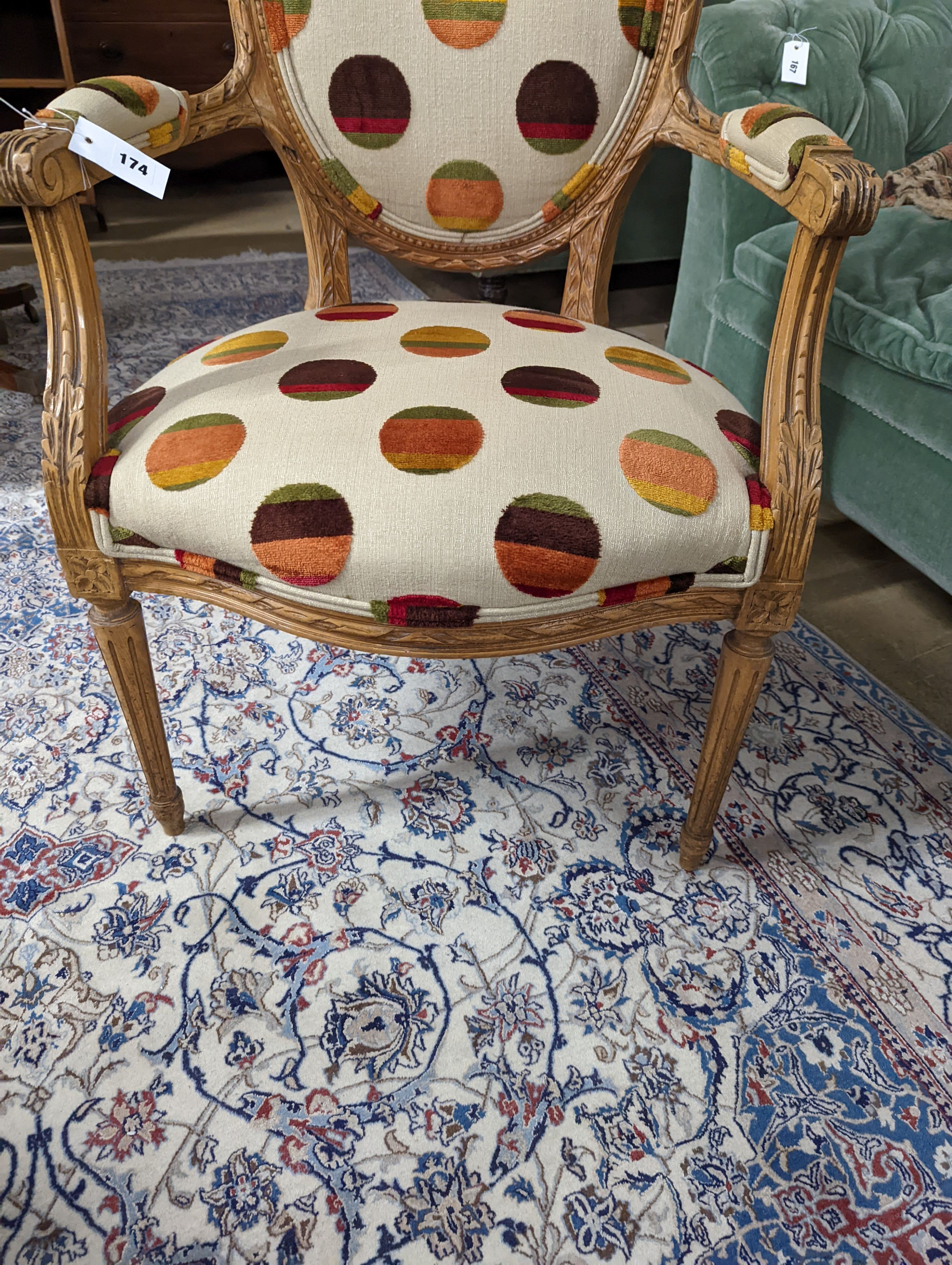 A Louis XVI style carved beech upholstered open armchair, width 62cm, depth 62cm, height 102cm
